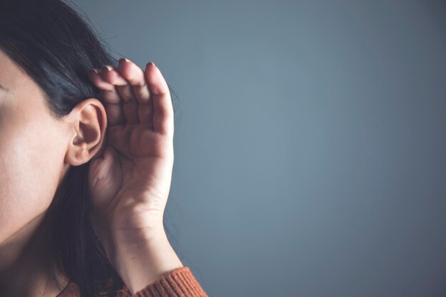 Woman hand in ear