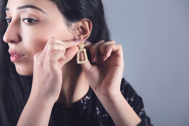 Woman hand elegant earring