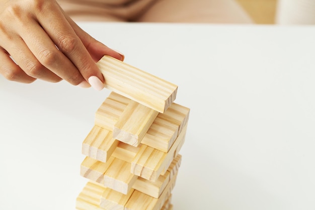 Woman hand of engineer playing a wood block