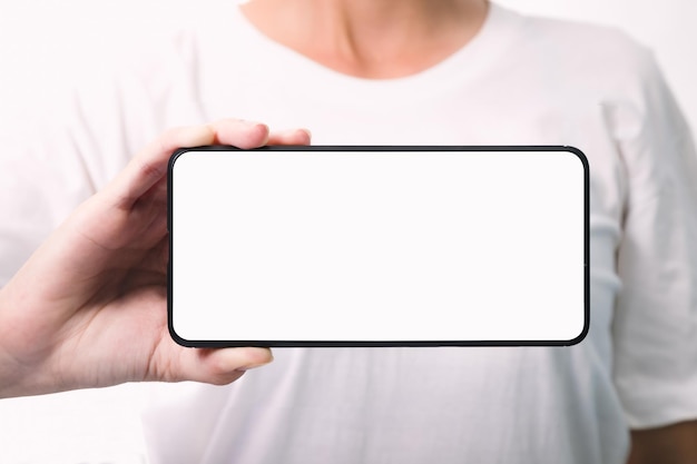 Woman hand holding the black smartphone with blank screen isolated on white background