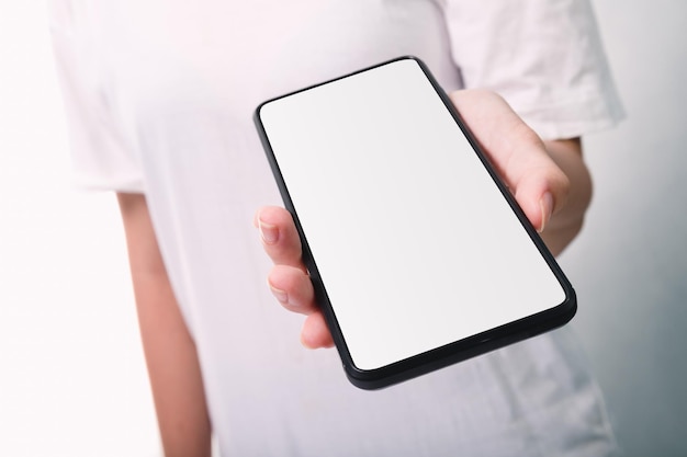 Woman hand holding the black smartphone with blank screen isolated on white background