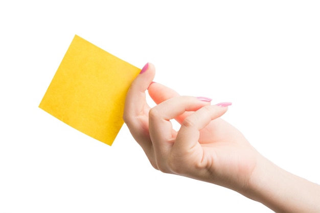 Woman hand holding blank yellow notepaper