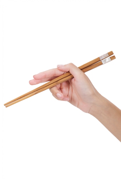 Woman hand holding chopsticks isolated on white 