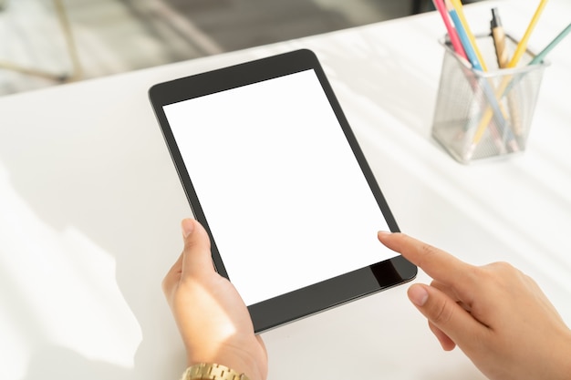 Woman hand holding digital tablet and the screen is blank