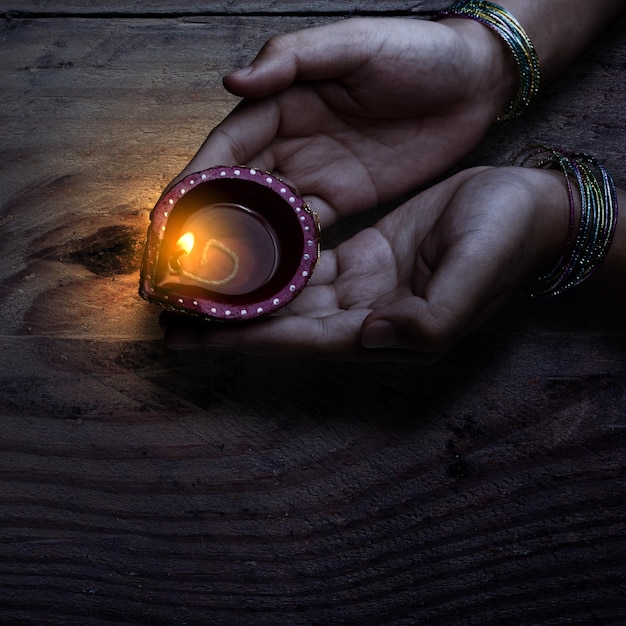 Woman hand holding Diya oil lamps for the Diwali festival Diwali Festival The Hindu Festival of Lights celebration