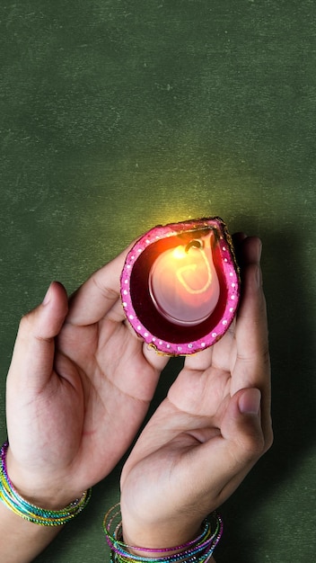 Woman hand holding Diya oil lamps for the Diwali festival Diwali Festival The Hindu Festival of Lights celebration