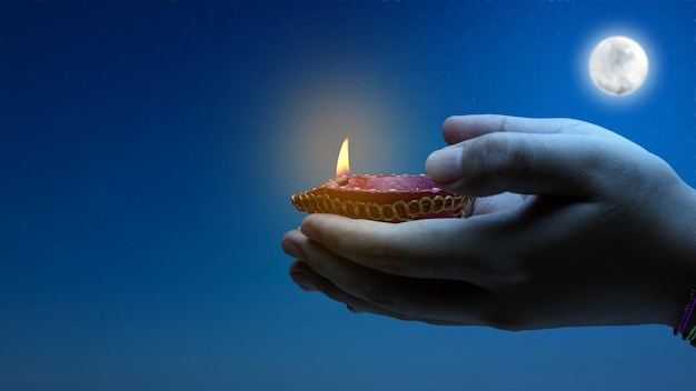 Woman hand holding Diya oil lamps for the Diwali festival Diwali Festival The Hindu Festival of Lights celebration