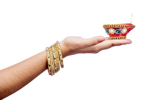 Woman hand holding Diya oil lamps for the Diwali festival