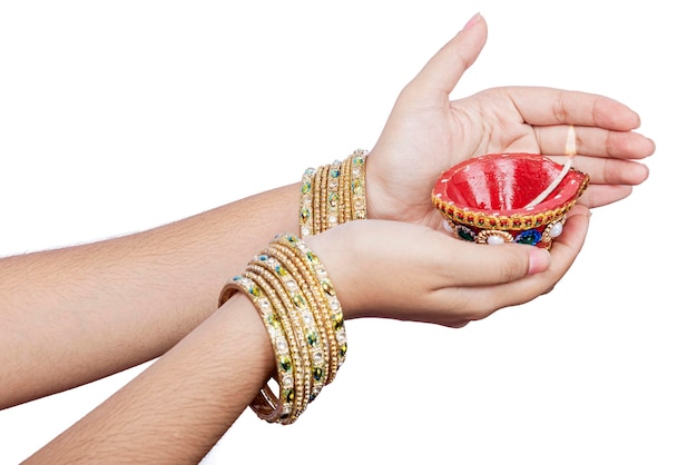 Woman hand holding Diya oil lamps for the Diwali festival