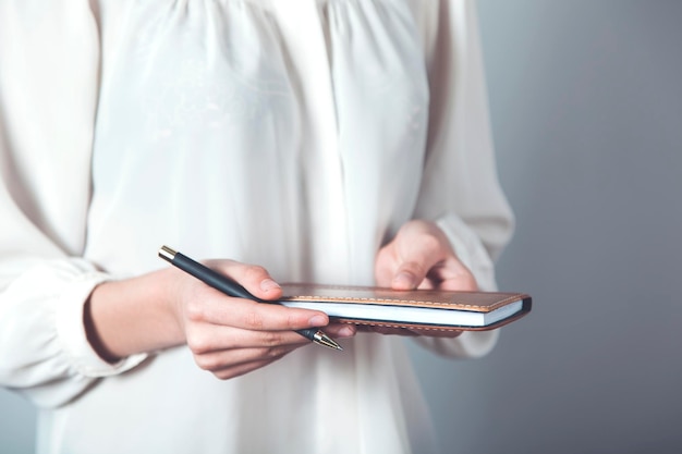 Woman hand holding notepad