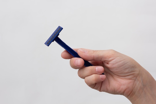 Woman hand holding razor