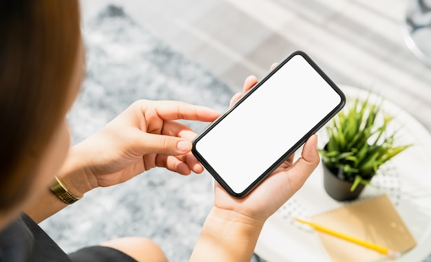 woman hand holding smartphone and the screen is blank, social network concept.