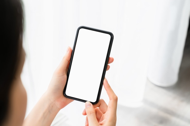 Woman hand holding smartphone and the screen is blank, social network concept