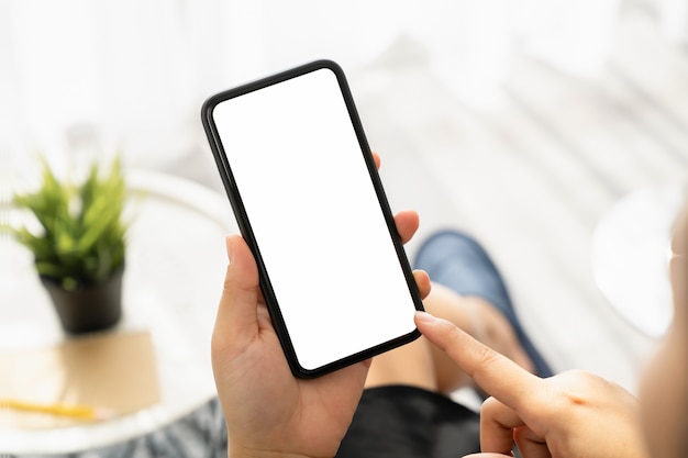 Woman hand holding smartphone and the screen is blank