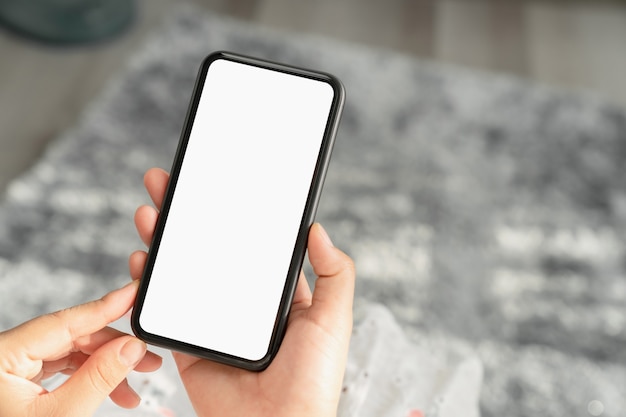 Woman hand holding smartphone and the screen is blank