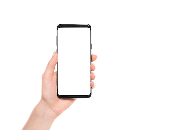 Woman hand holding smartphone with blank white screen