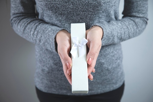 Woman hand holding white box