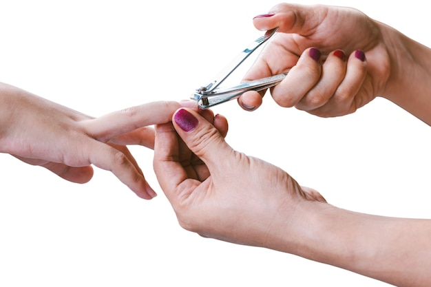 Woman hand is using a nail clipper to cut a child fingernails isolated