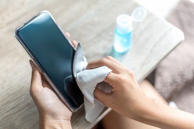 Woman hand is wiped clean with a cloth and alcohol.