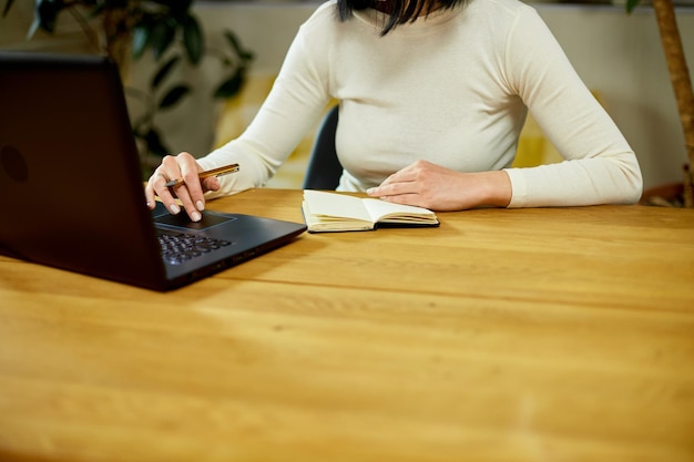 Woman hand making notes in notepad businesswoman freelancer