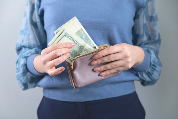 Woman hand money with wallet