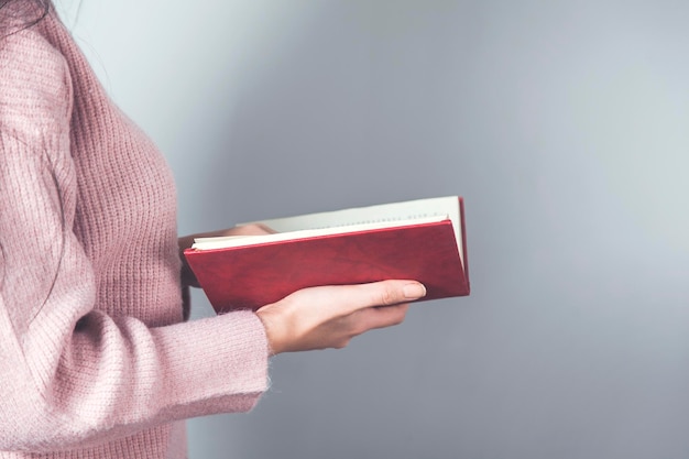 Woman hand red book