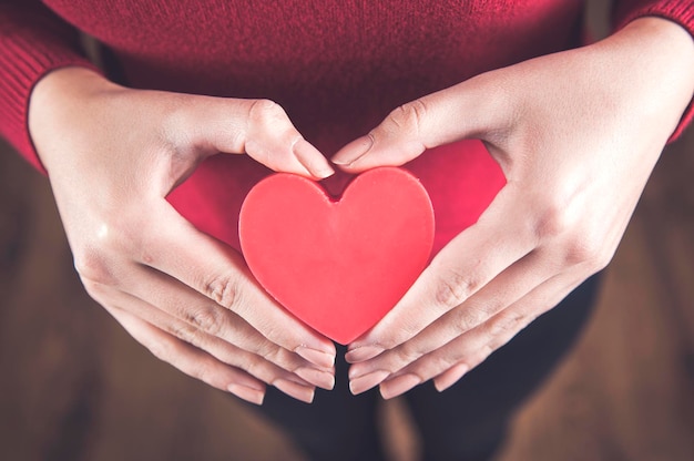 Woman hand red heart