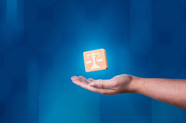 Woman hand showing balance justice icon with modern blue background. Legal advice technology service