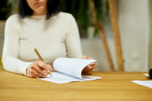 Woman hand signing a contract making a deal with business partner