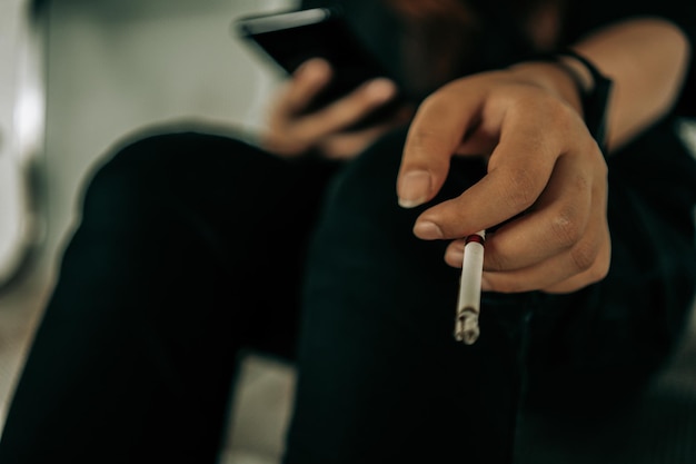 Woman hand smoking cigarette unhealthy lifestyle concept