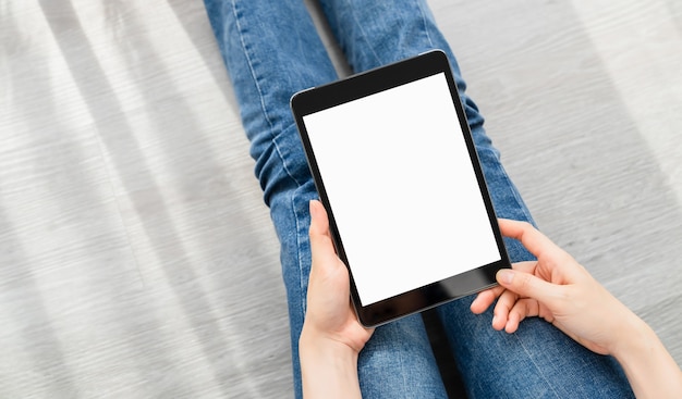 Woman hand using digital tablet and the screen is blank.