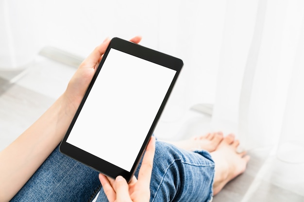 Woman hand using digital tablet and the screen is blank.