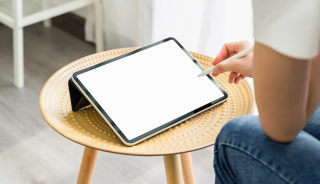 Woman hand using digital tablet and the screen is blank.