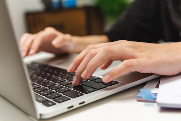 Woman hand using keyboard computer laptop internet communication social network digital technology