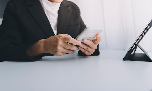 Woman hand using mobile smart phone online payment banking and online shopping at the home