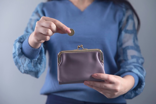 Woman hand wallet with coins