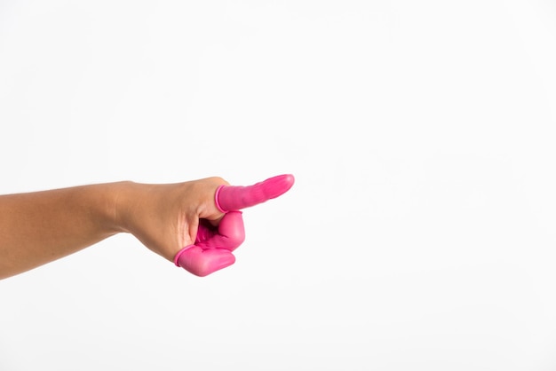 Woman hand wearing pink finger cots rubber