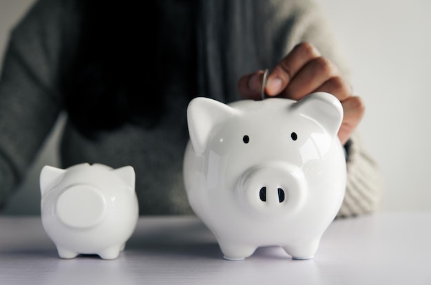 Woman hand and white piggy bank to saving money concept budget financial