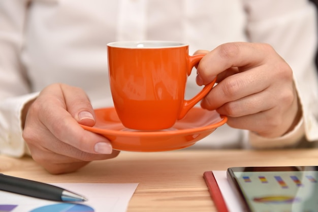 Woman hand with coffee cup