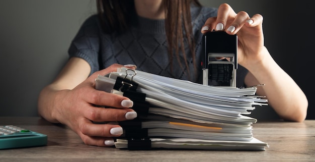 Woman hand with stamping documents