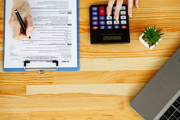 Woman hand writing or signing in a document