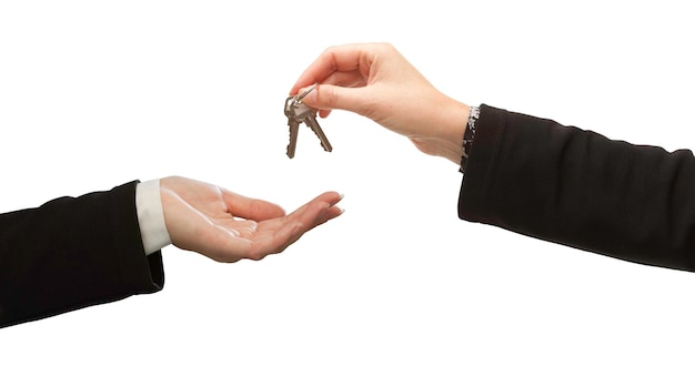 Photo woman handing over woman set of keys isolated on white