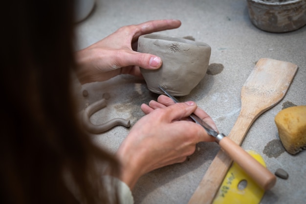 Woman hands are manufacturing an beautiful ceramic mug