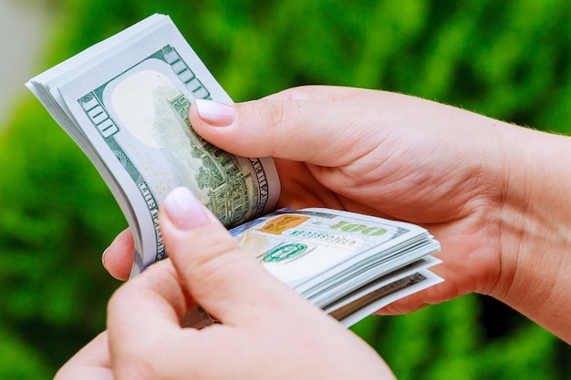 Woman hands counting dollar banknotes. Spend money.