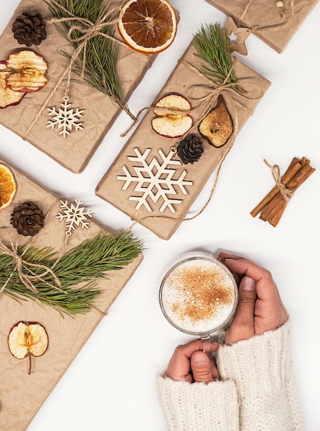 woman hands hold mug of latte coffee cozy winter holiday background