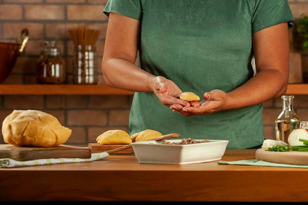 Woman hands holding brazilian snacks beef stufing croquette risolis de carne