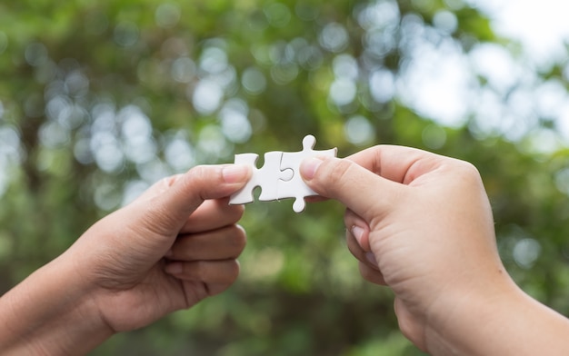 woman hands holding jigsaw puzzles