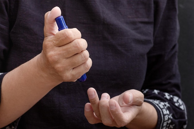 Woman hands holding lancet to prick finger to check sugar in blood