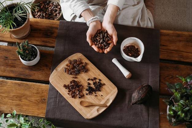 Woman hands holding organic cacao beans for ceremony