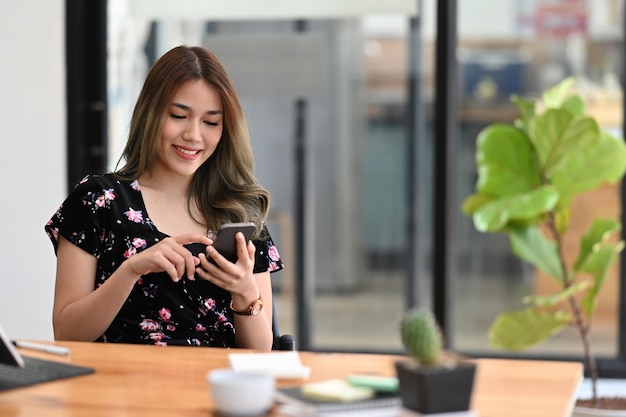 Woman hands holding smart phone with white empty screen for advertise